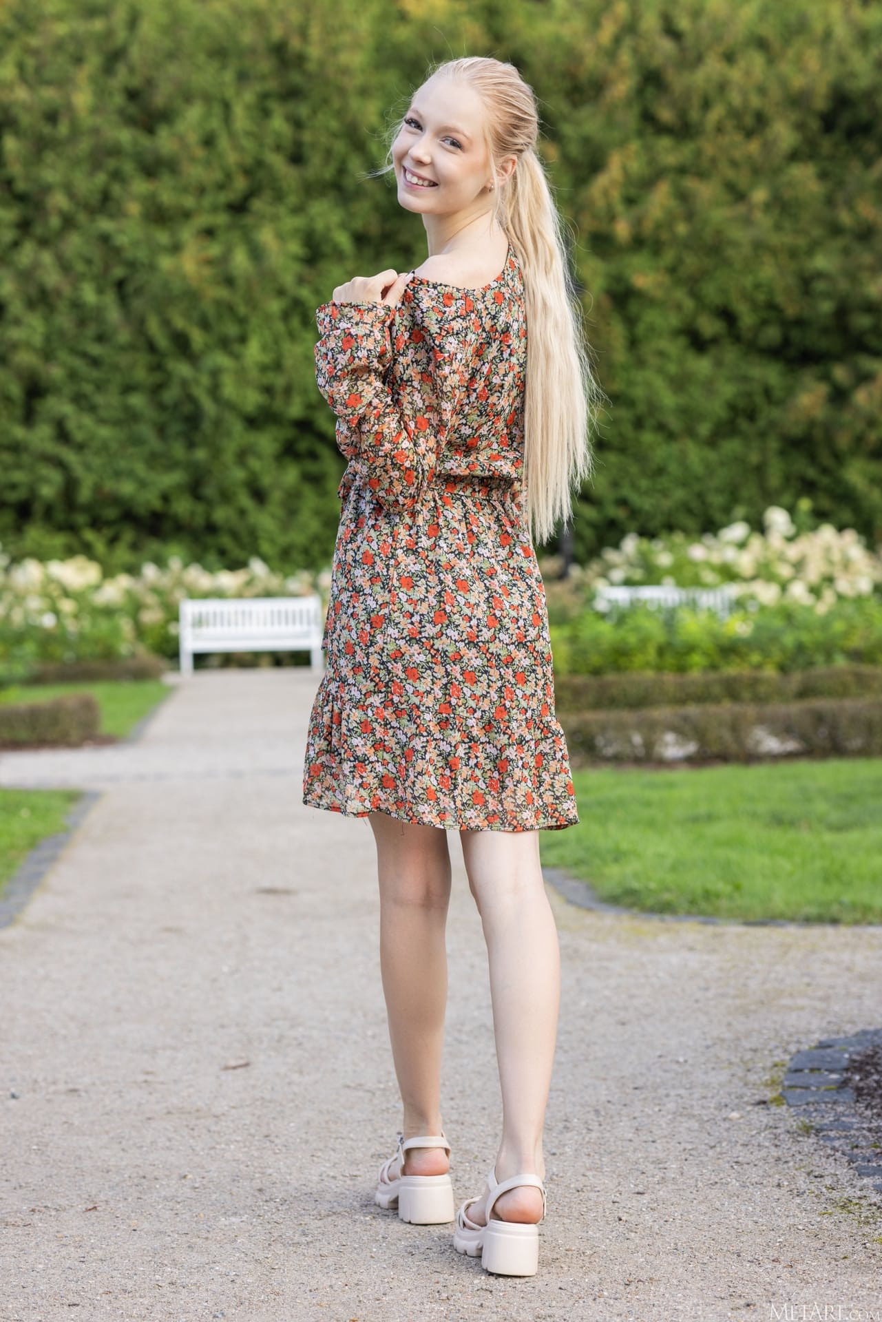 Cute blonde teen shows her natural tits and tight pink slit in a garden