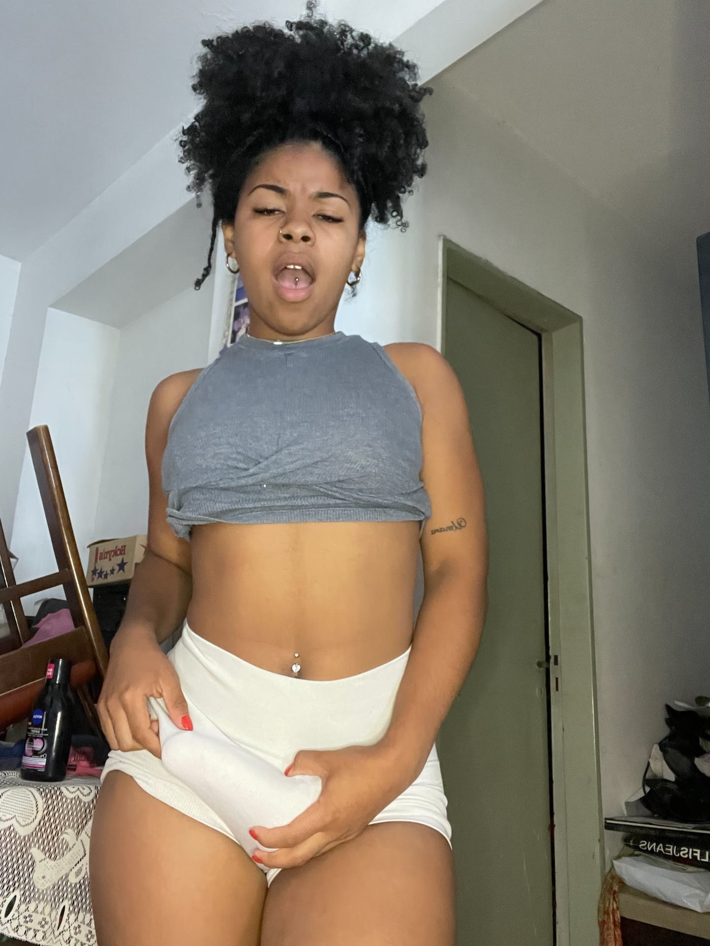 Ebony solo girl with a full head of curly hair models a lot of outfits