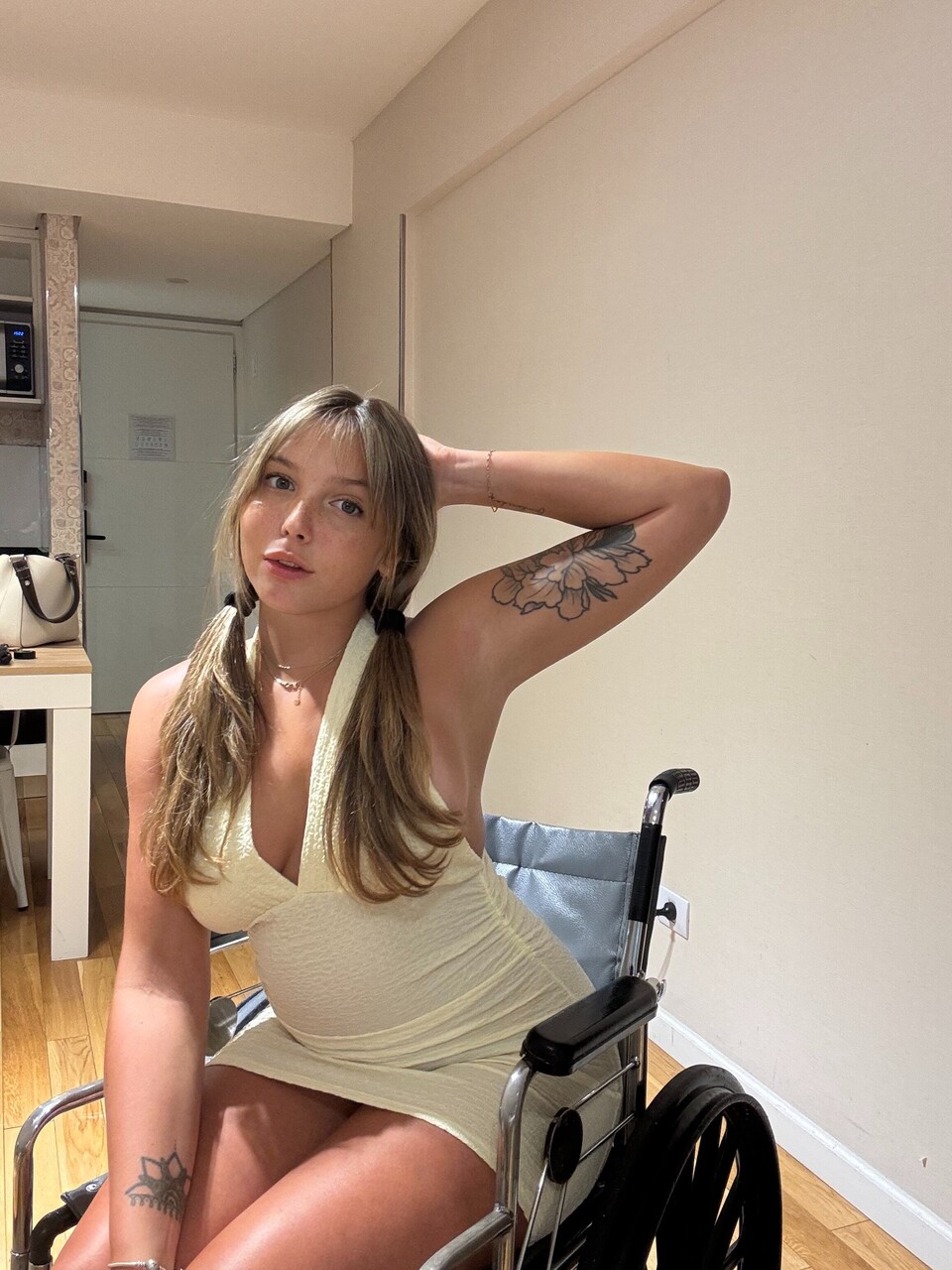Young blonde removes a thong from her tight dress while in a wheelchair