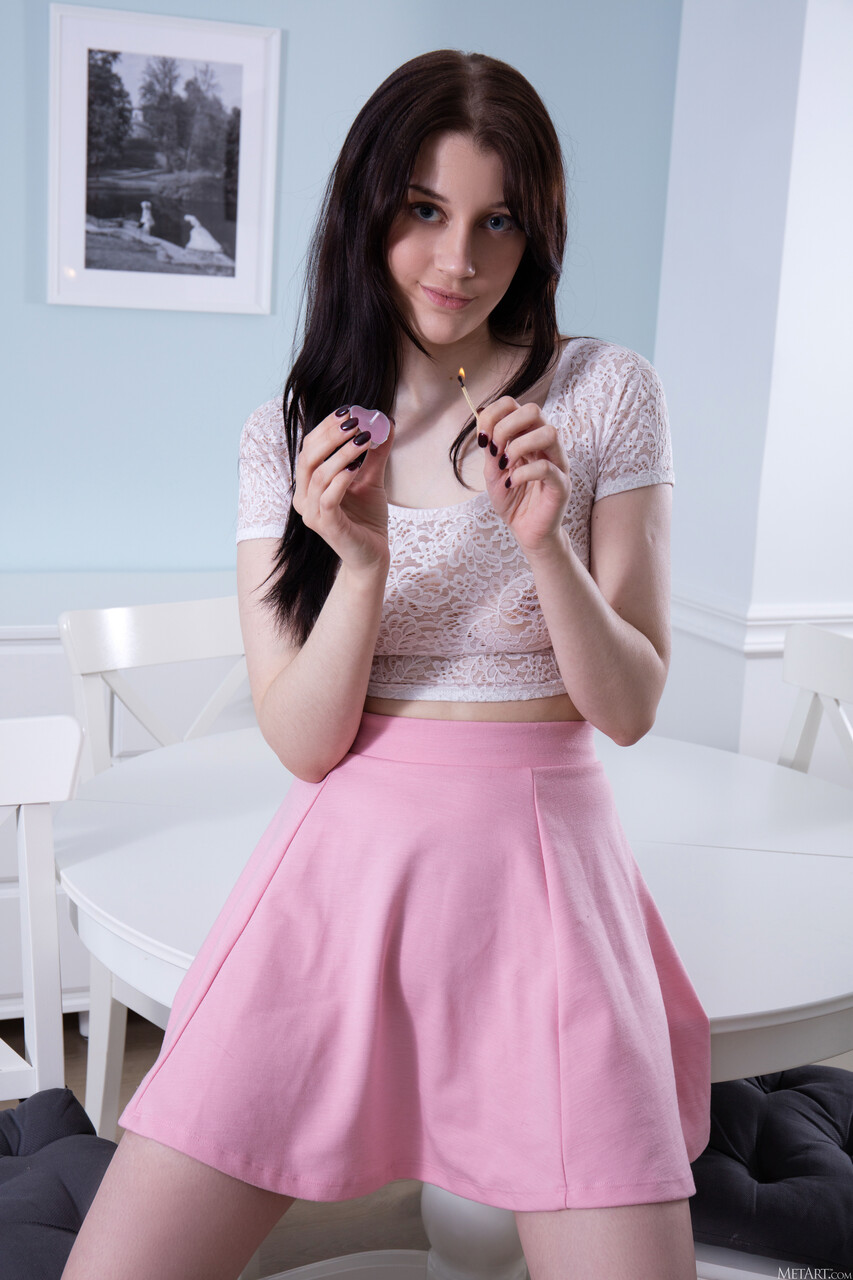 Young beauty with dark hair displays her flexibility while getting totally naked