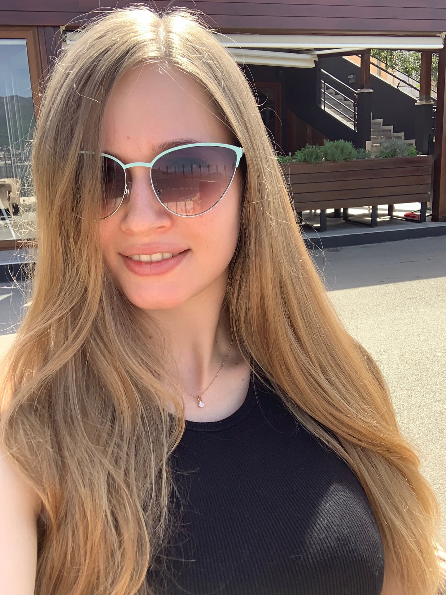 Solo girl with long blonde hair takes selfies in a variety of outfits