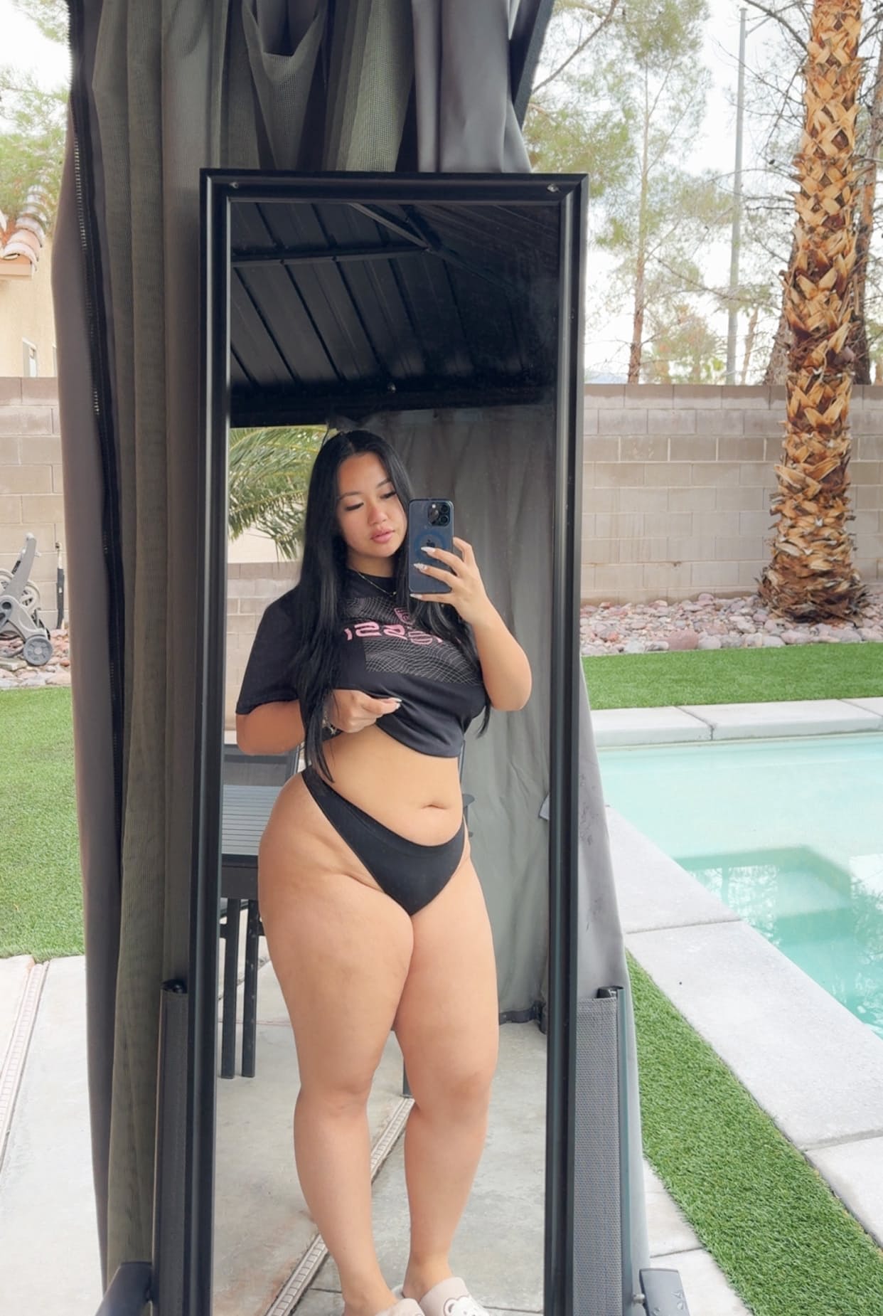 Solo model with long dark hair poses in outdoor swimwear and sexy lingerie