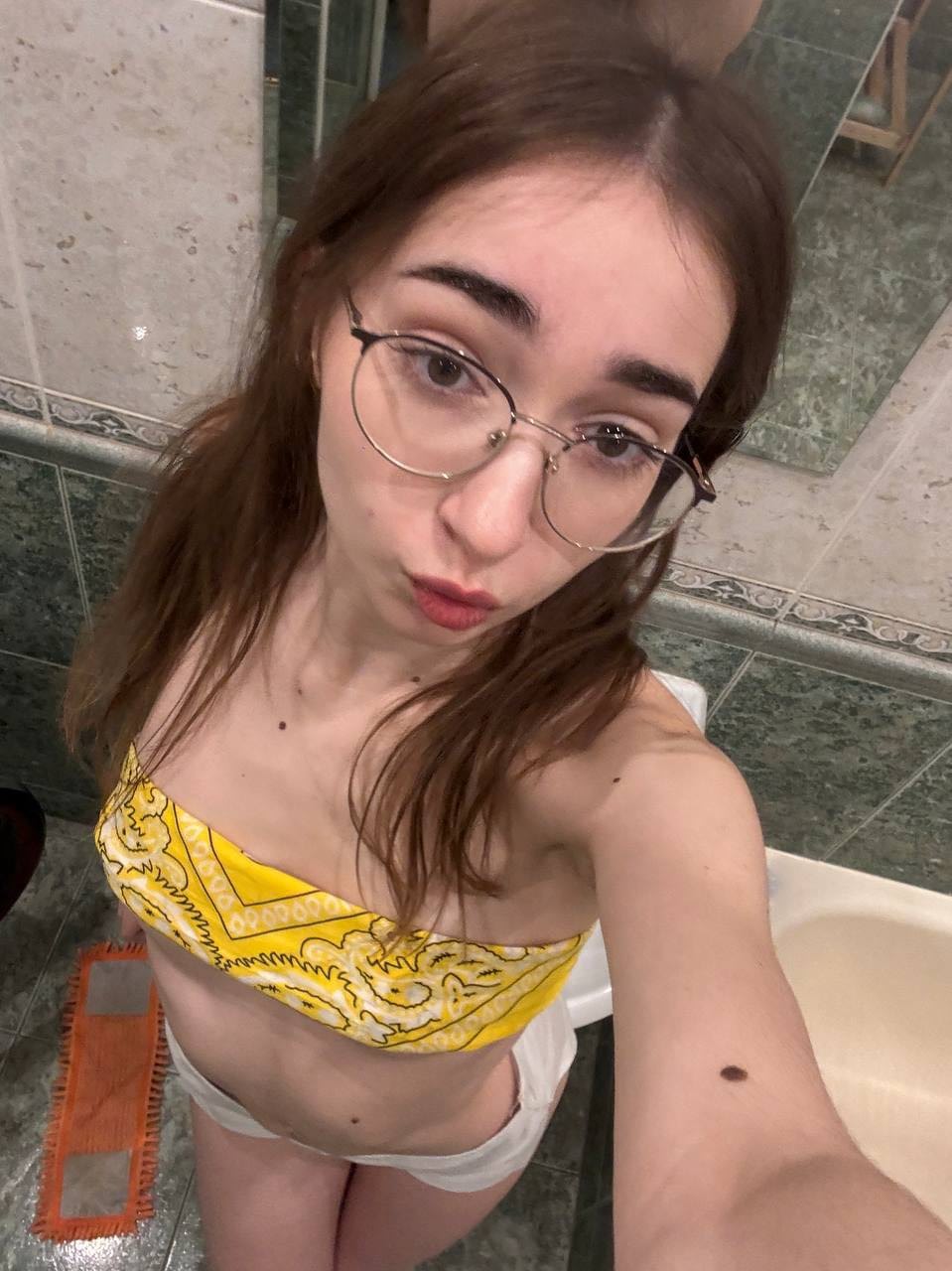 Glasses clad teen strikes great solo poses while mostly clothed