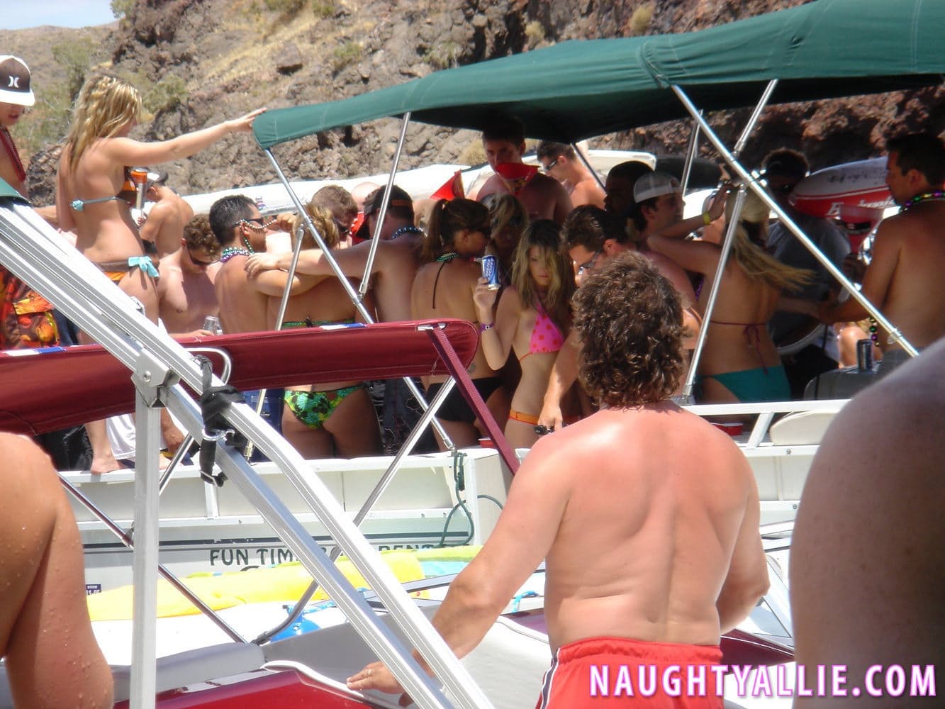 Blonde amateur Naughty Allie engages in lesbian play during a boat party