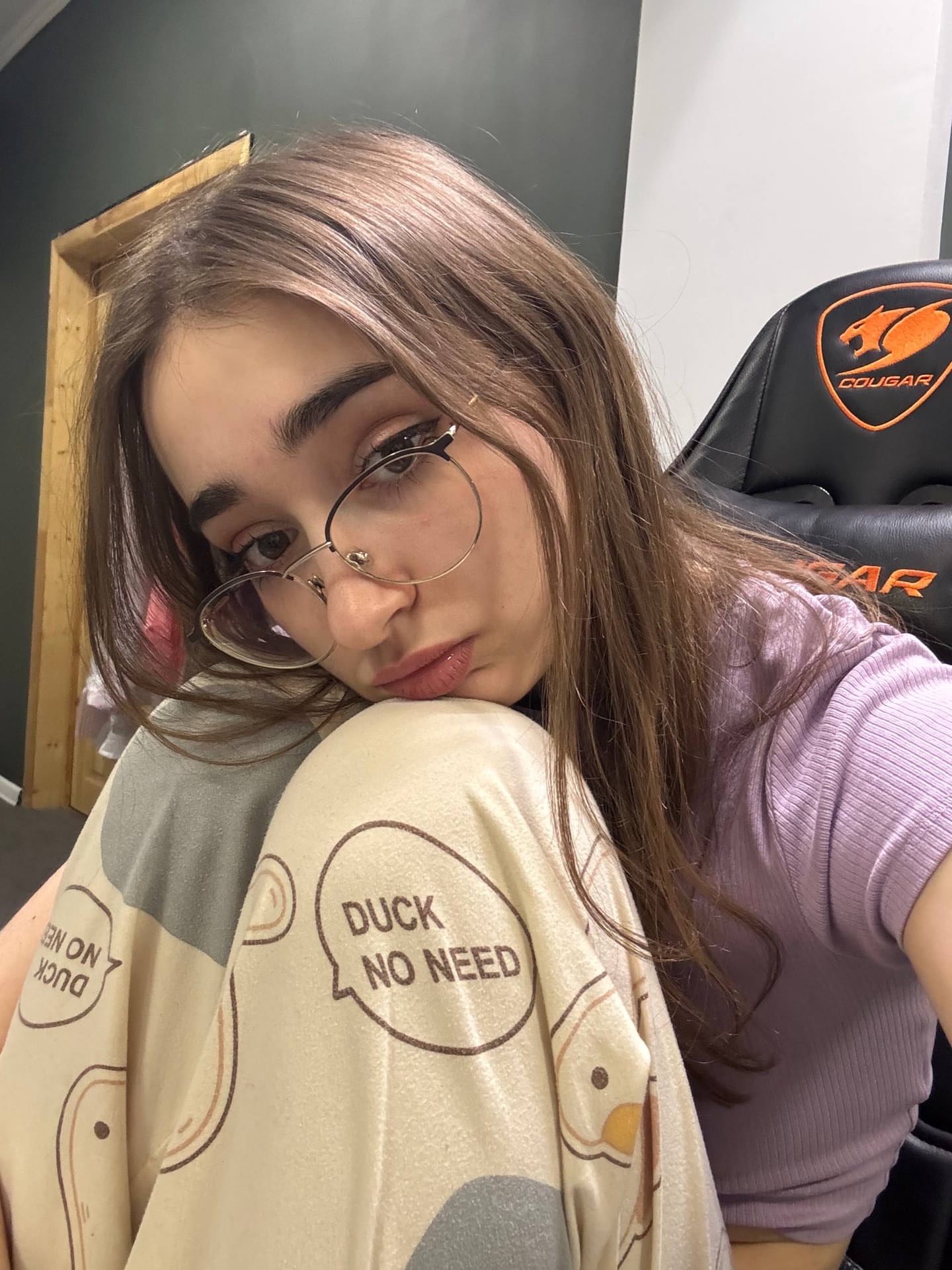Thin teen with long hair takes selfies while wearing her glasses