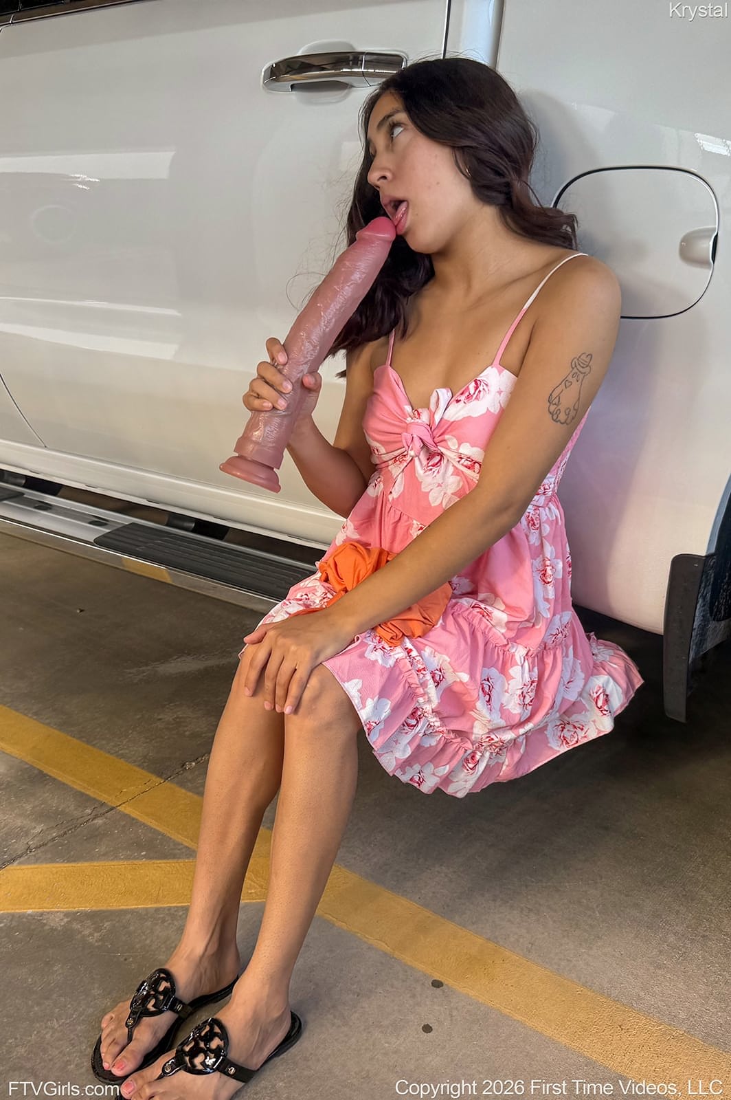 Cute brunette masturbates with a big dildo in the back of a car