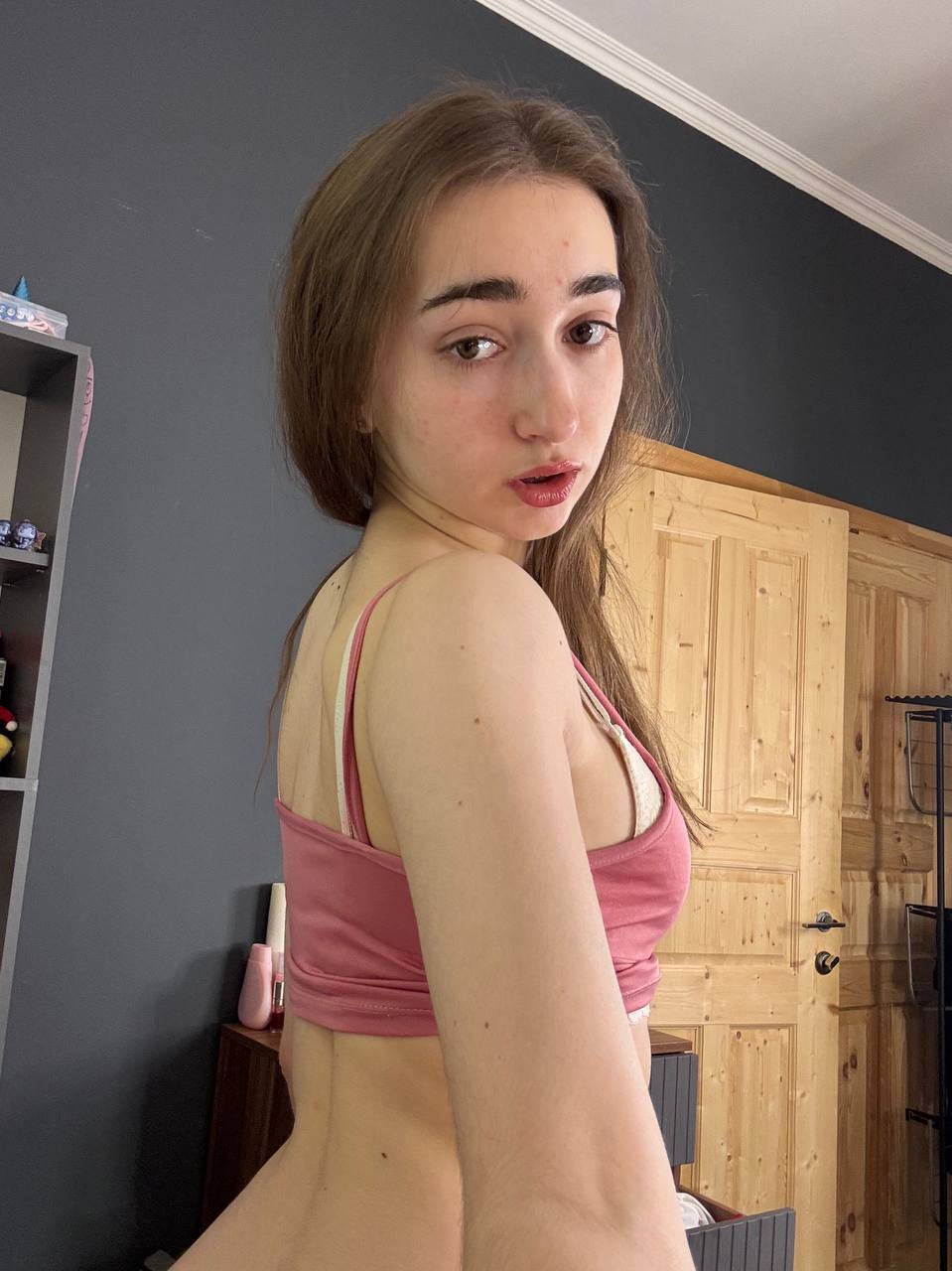 Amateur girl with glasses and long hair takes selfies in revealing outfits