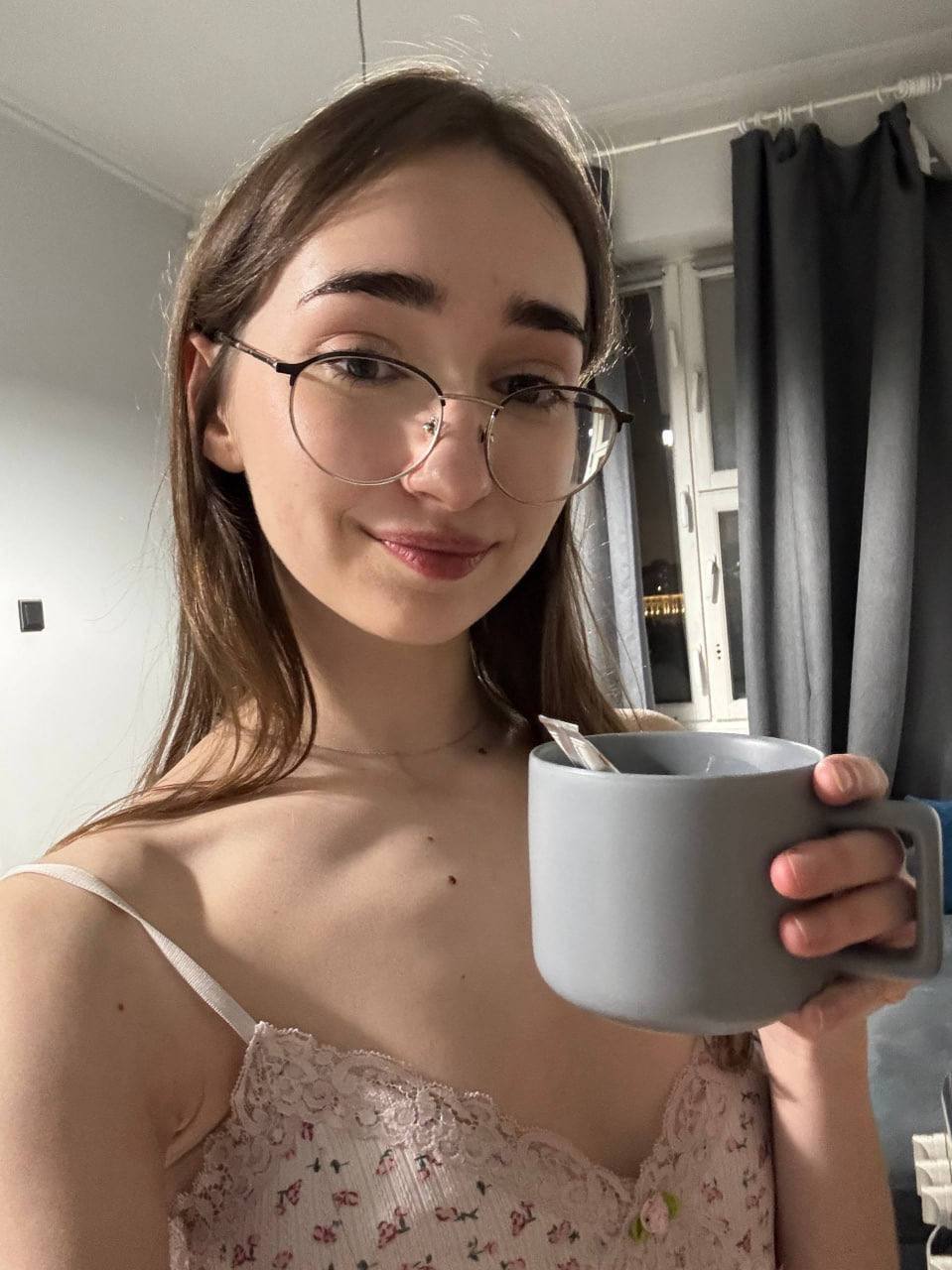 Amateur girl with glasses and long hair takes selfies in revealing outfits