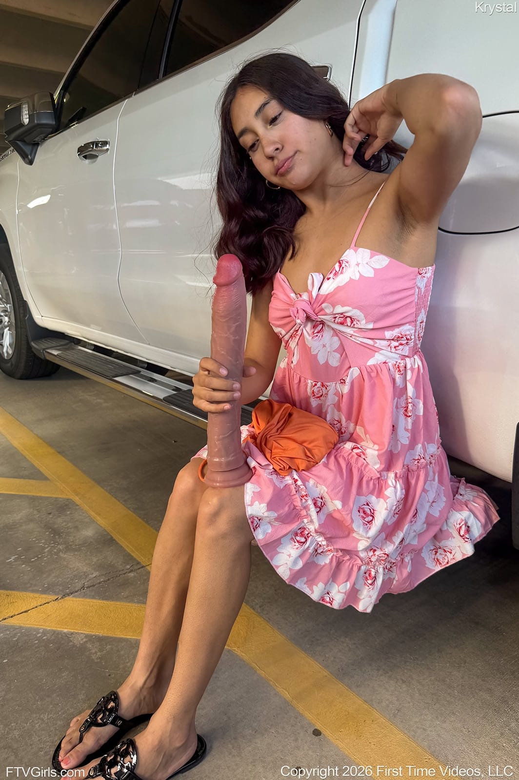 Cute brunette masturbates with a big dildo in the back of a car