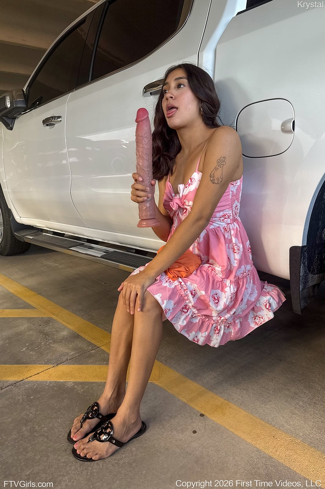 Cute brunette masturbates with a big dildo in the back of a car