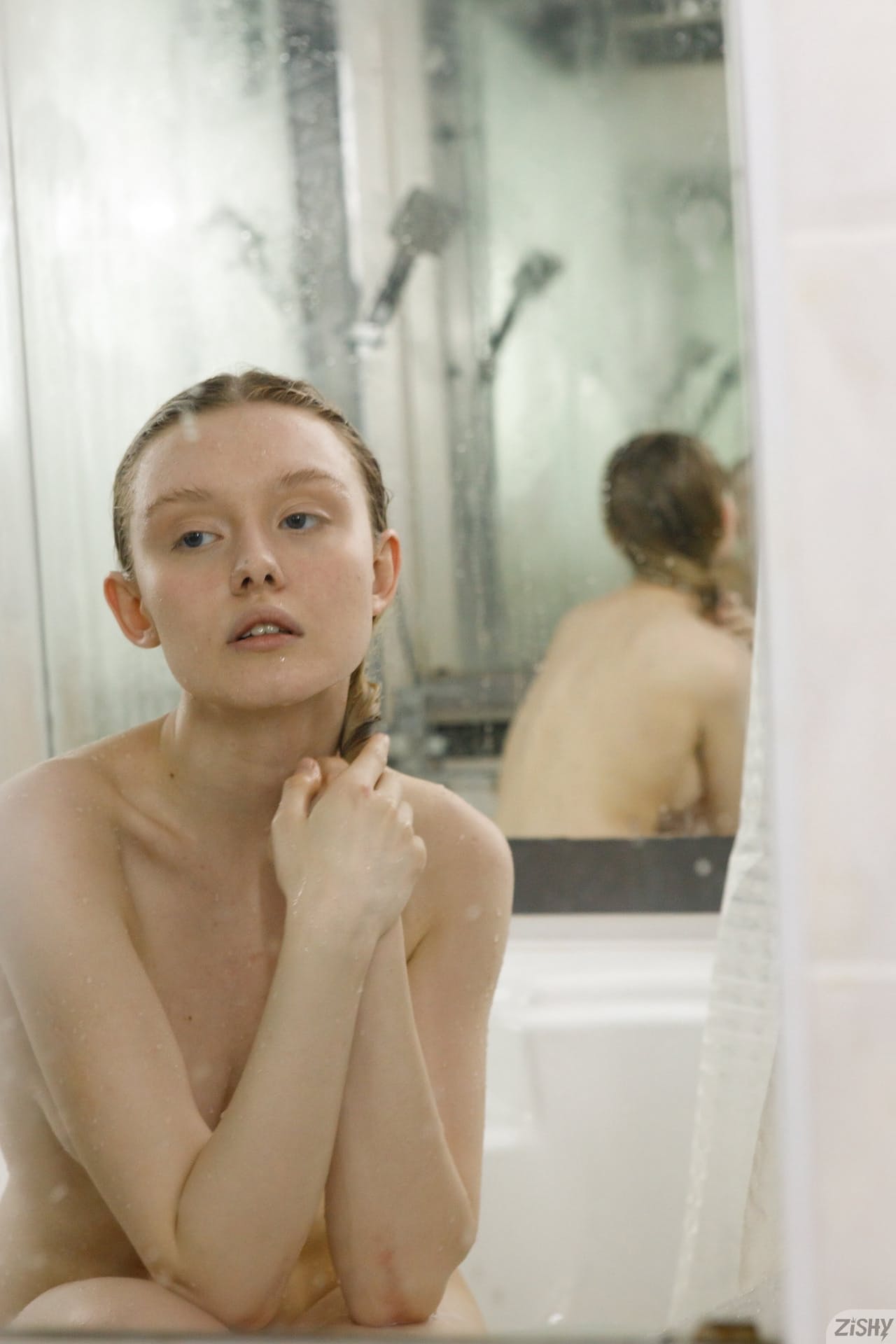 Petite babe Cami Sembrabella shows her perky tits while naked in a shower