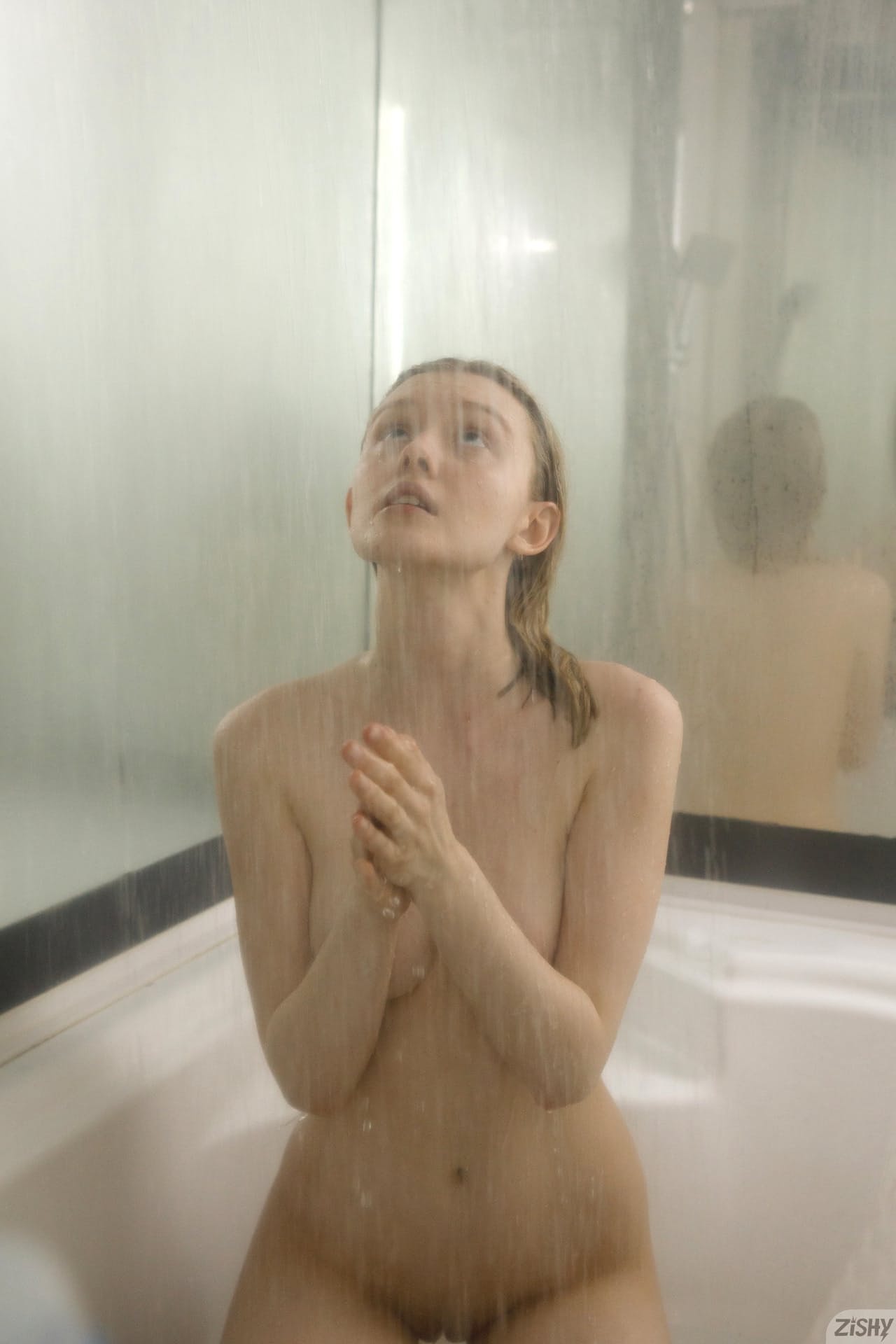 Petite babe Cami Sembrabella shows her perky tits while naked in a shower