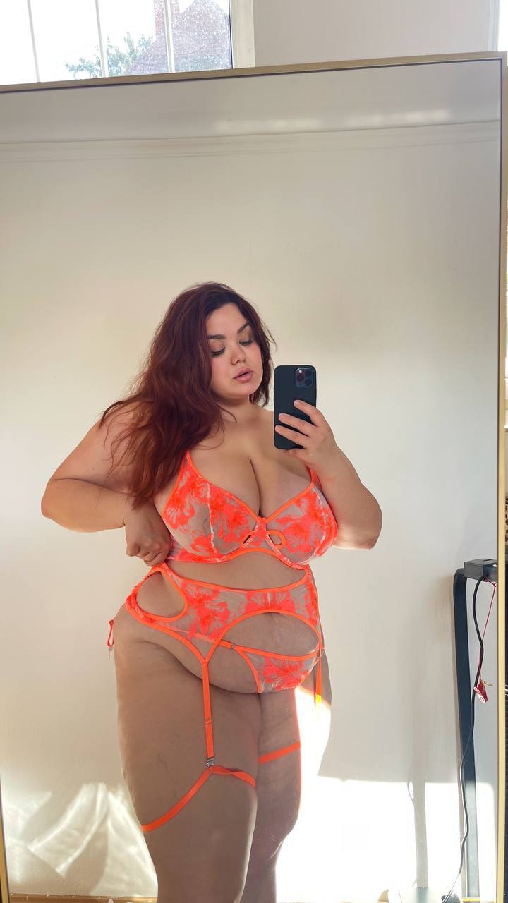 Solo girl takes selfies while wearing revealing lingerie and hosiery