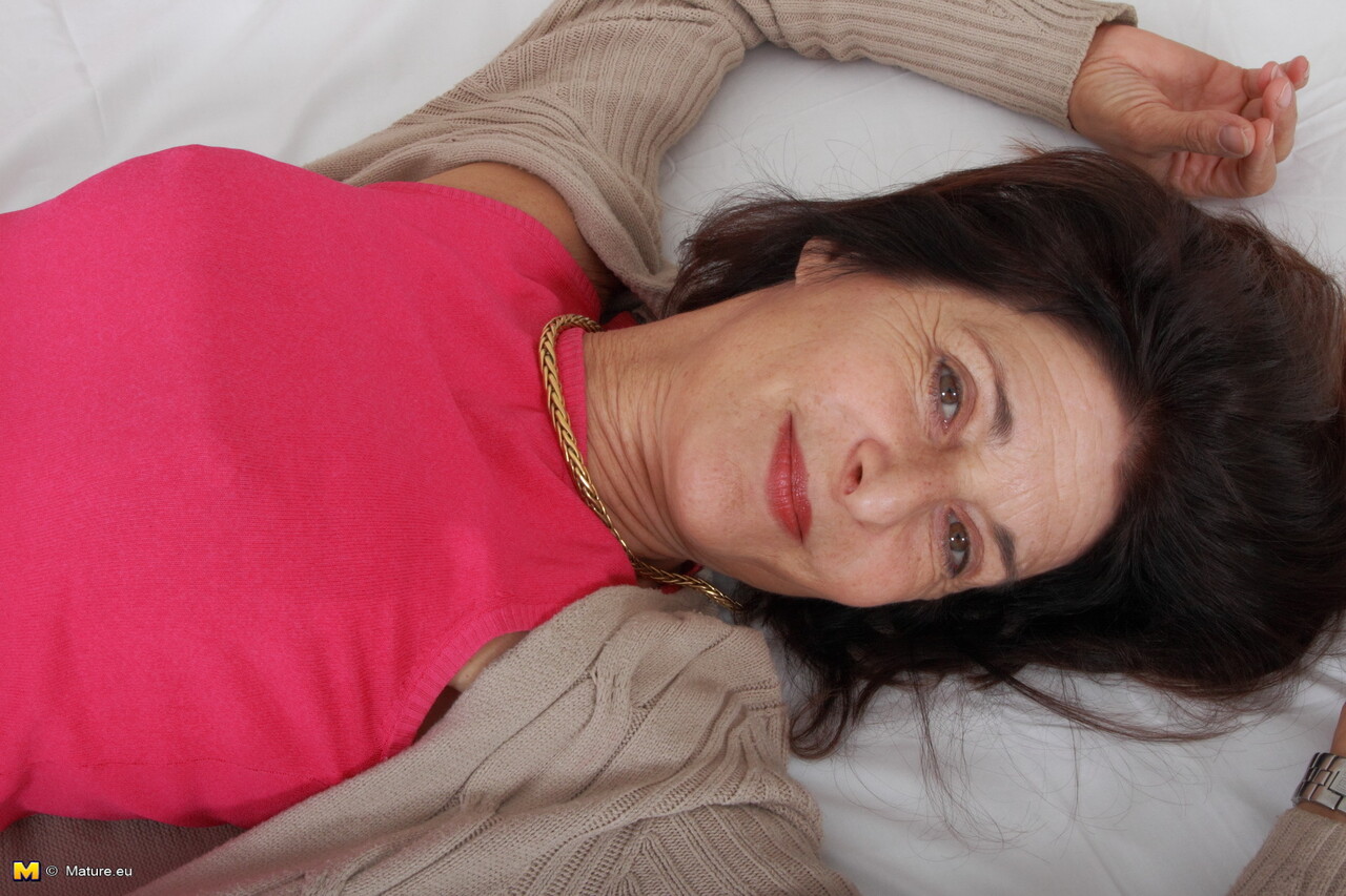 Mature woman exposes her sexy underwear while wearing sheer nylons