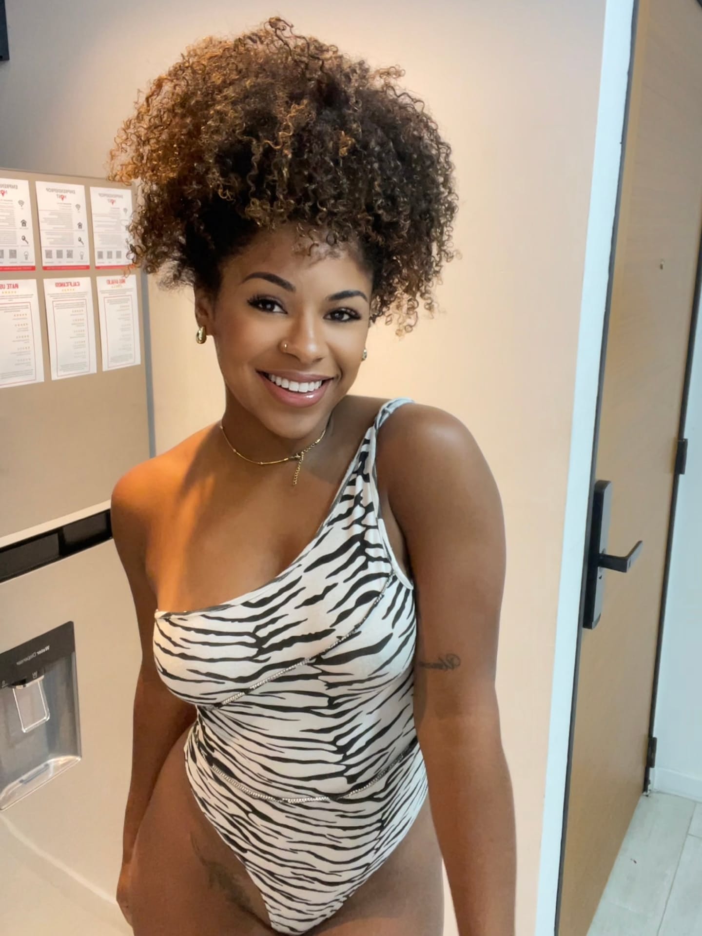 Ebony solo girl with a full head of curly hair models a lot of outfits