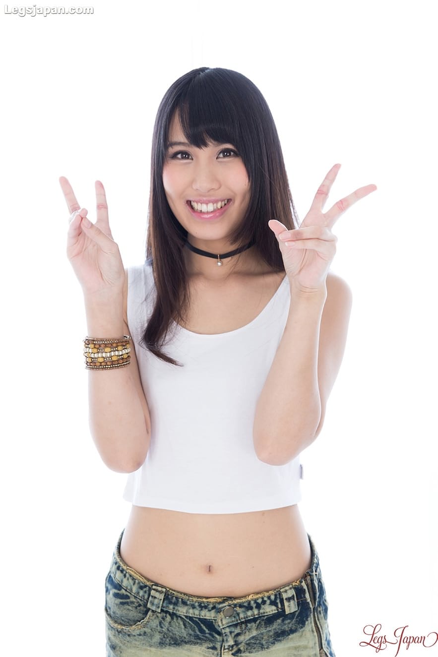 Japanese girl with long legs displays her tight ass while getting naked