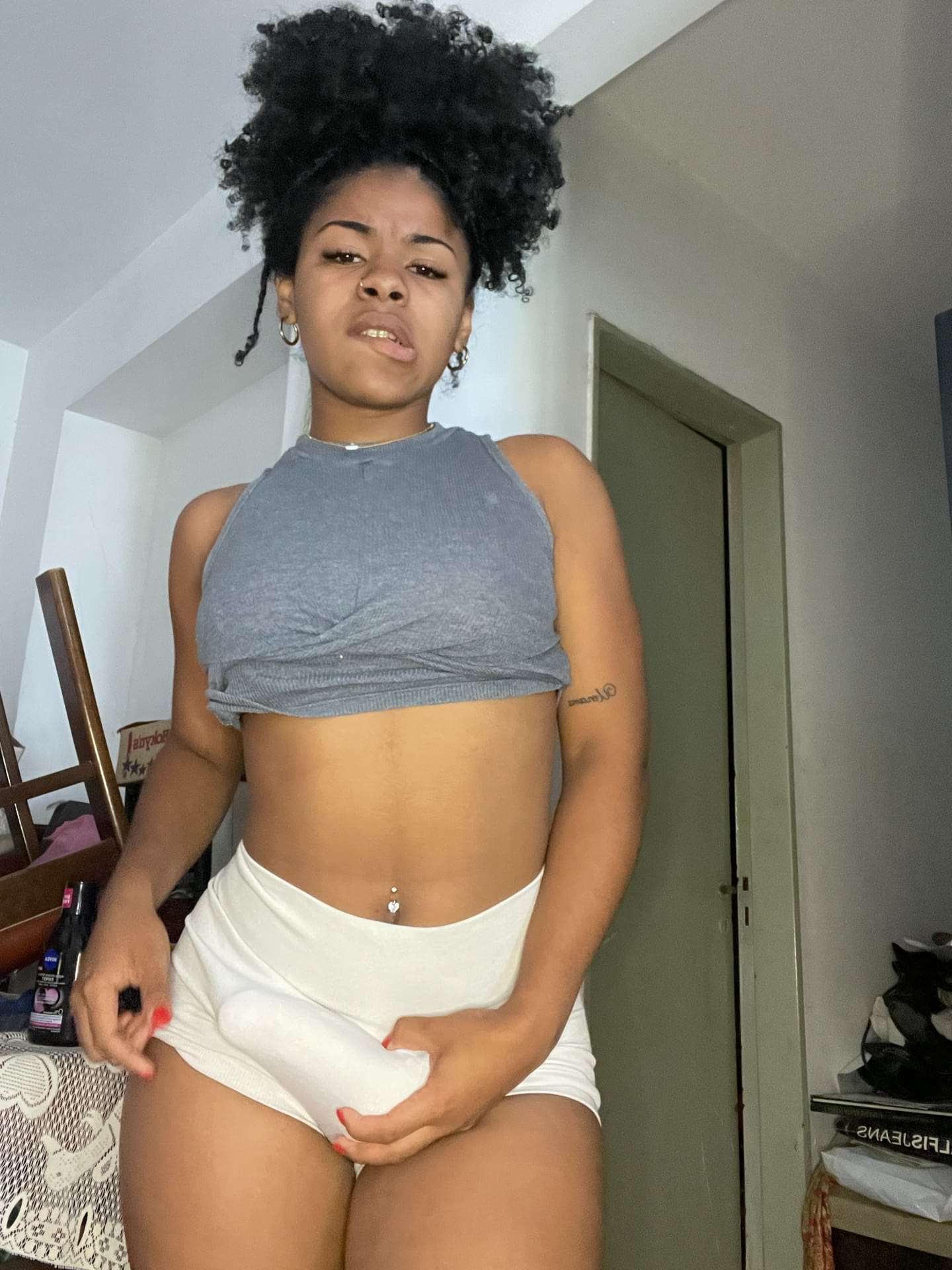 Ebony solo girl with a full head of curly hair models a lot of outfits