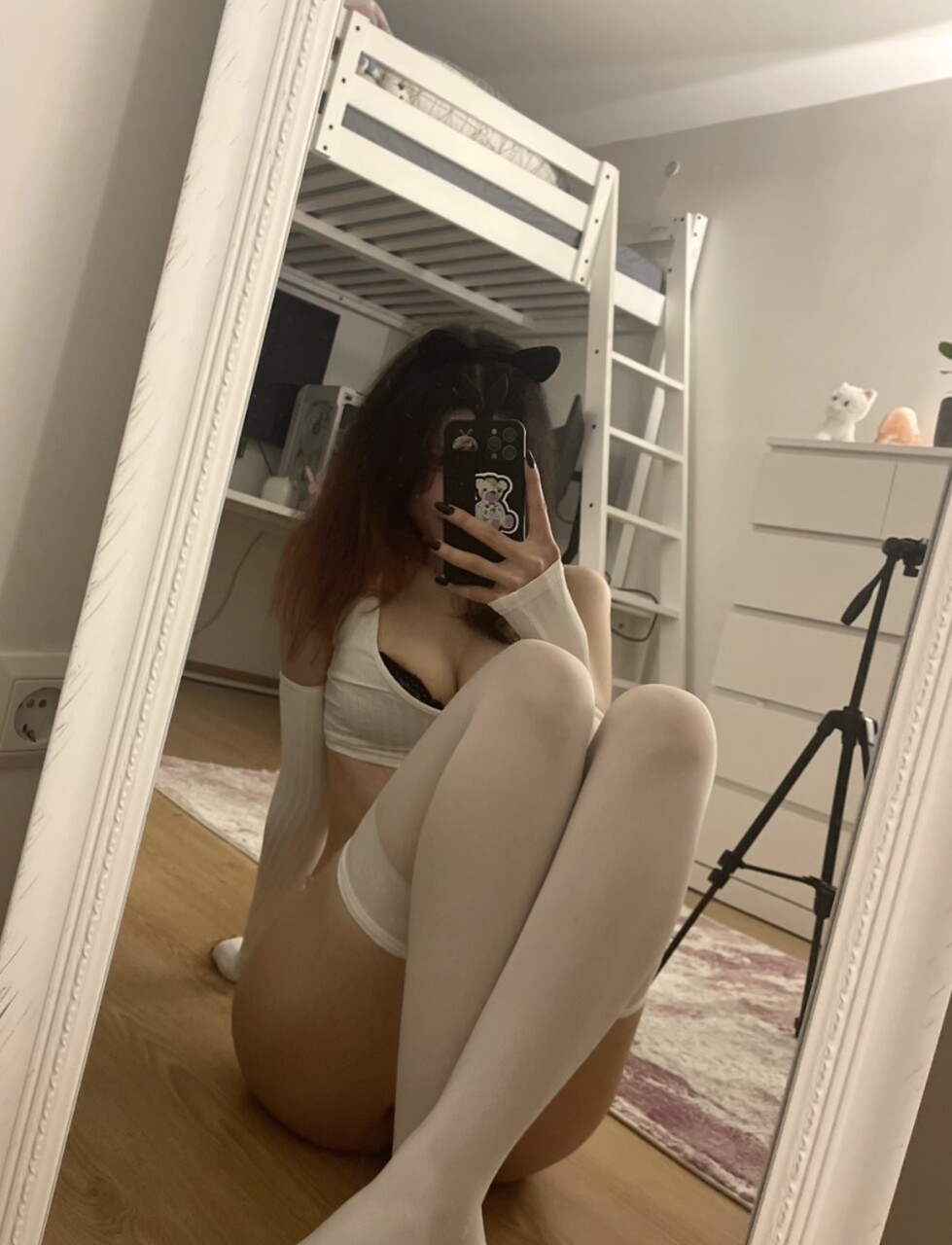 Young amateur takes selfies while getting naked in her bedroom