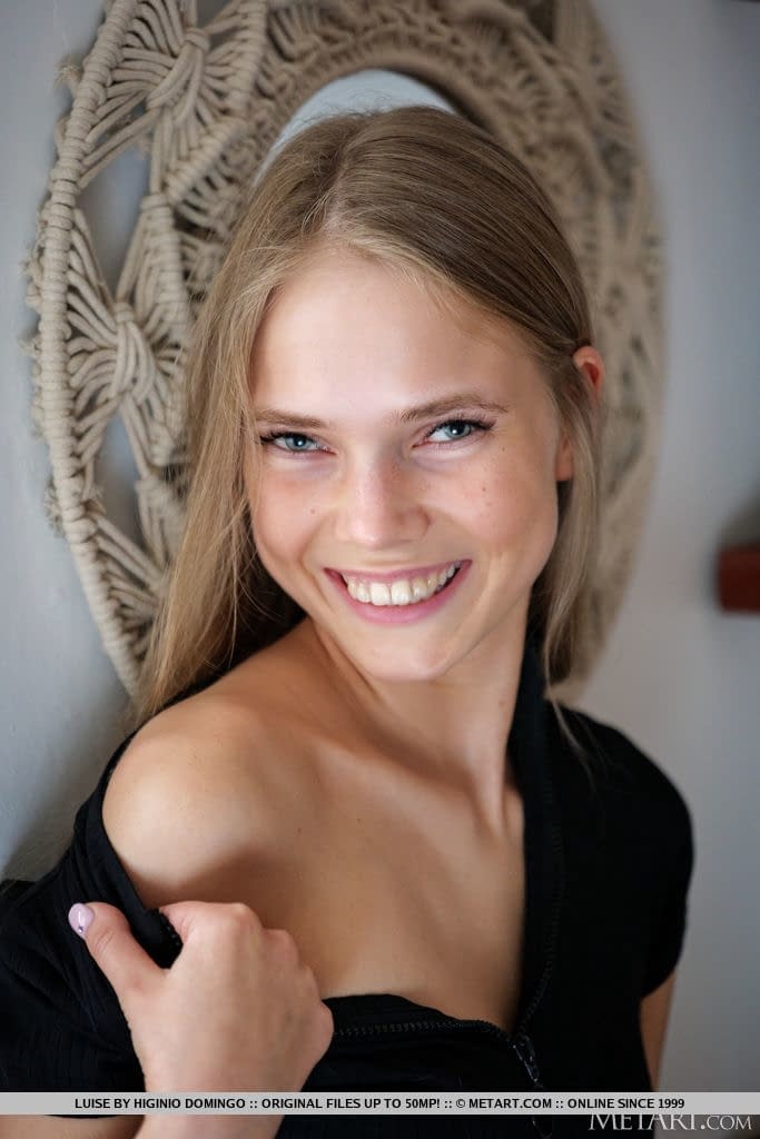 Young blonde removes a black dress to model in the nude during solo action