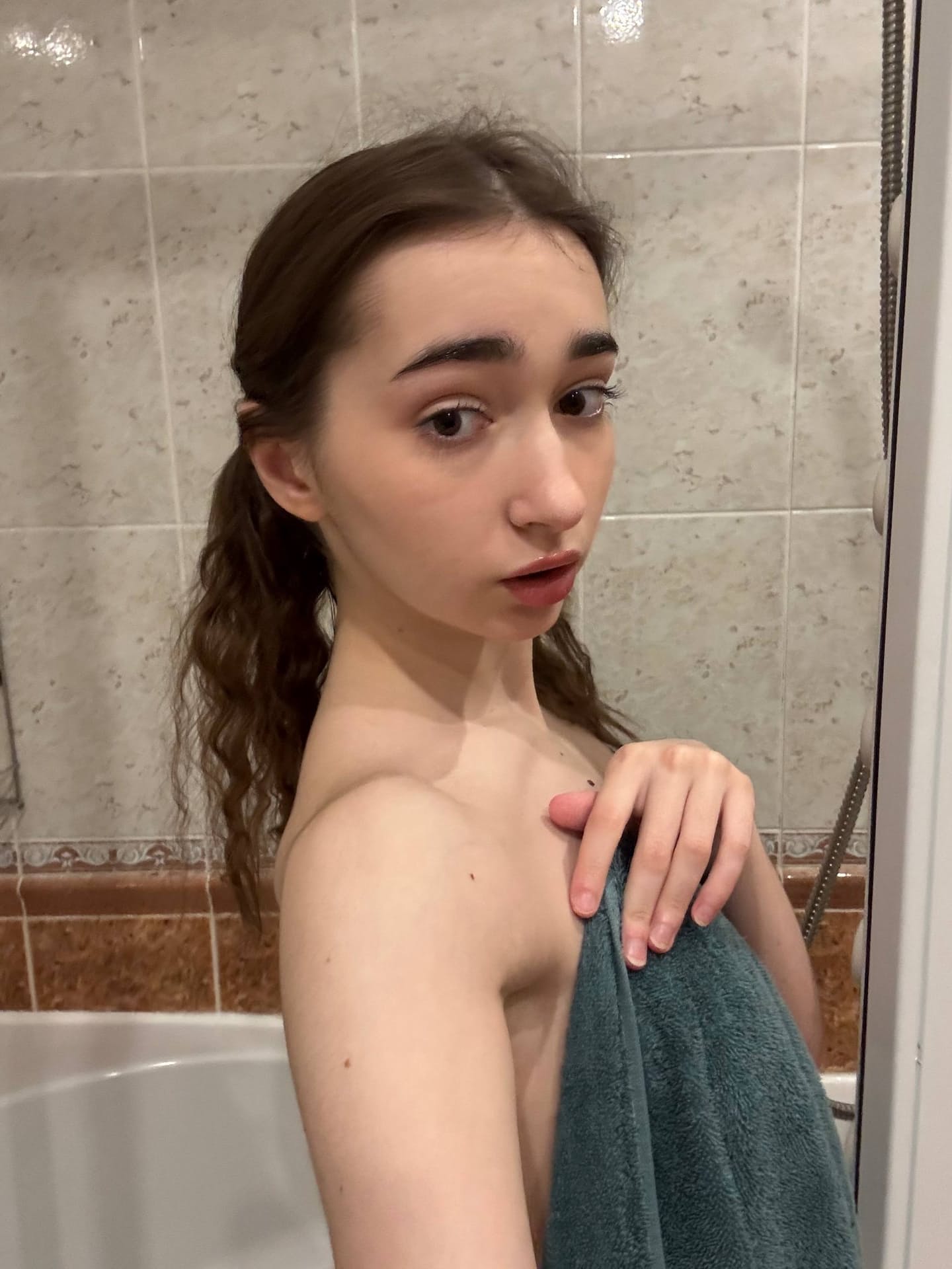 Amateur girl with glasses and long hair takes selfies in revealing outfits