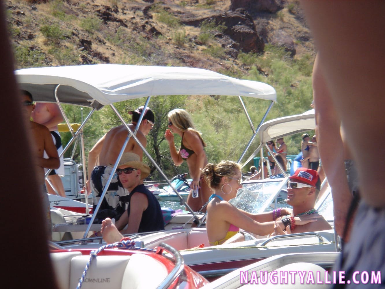 Blonde amateur Naughty Allie engages in lesbian play during a boat party