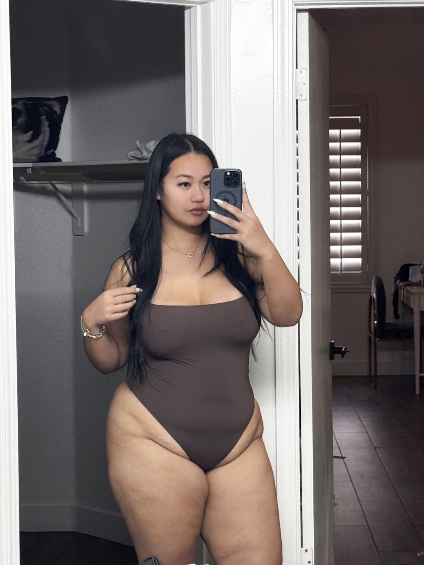 Solo model with long dark hair poses in outdoor swimwear and sexy lingerie