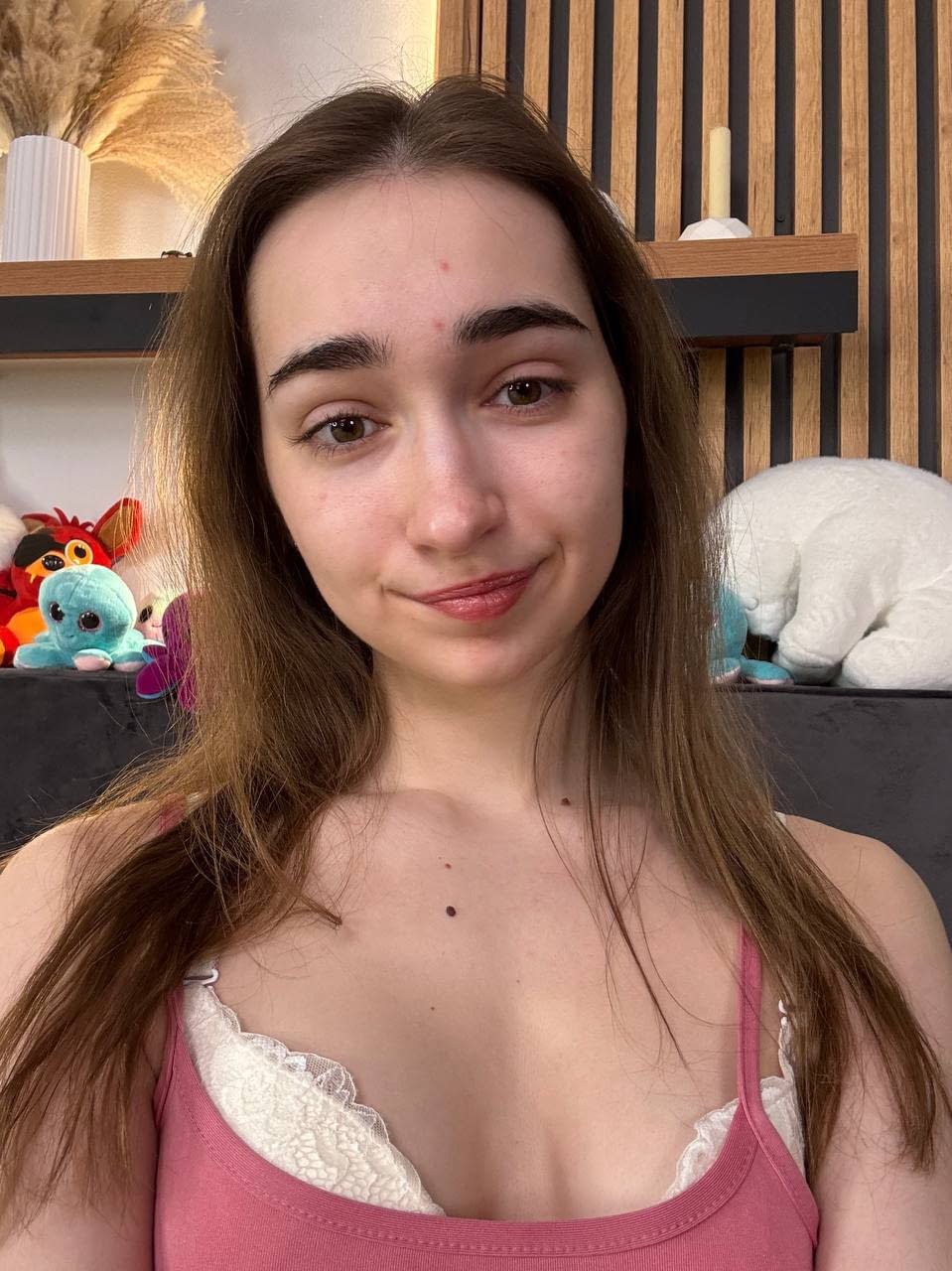 Amateur girl with glasses and long hair takes selfies in revealing outfits