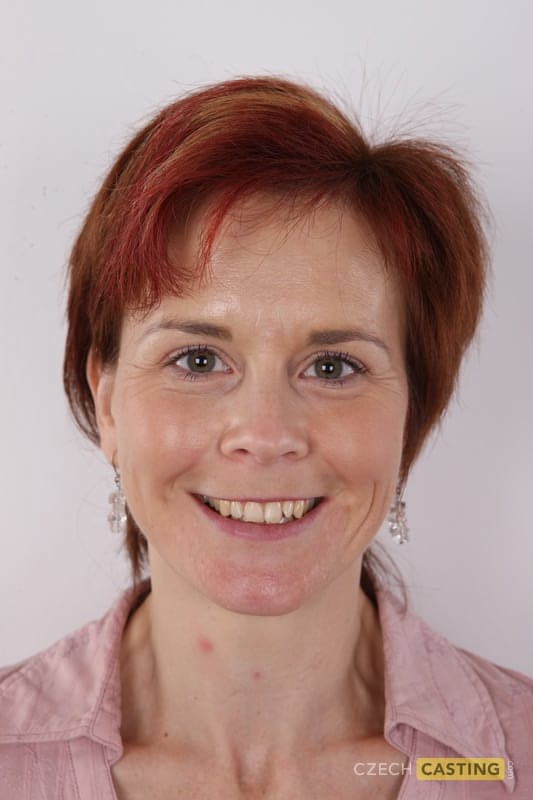 Amateur MILF with short red hair stands naked during a close-up of her pussy