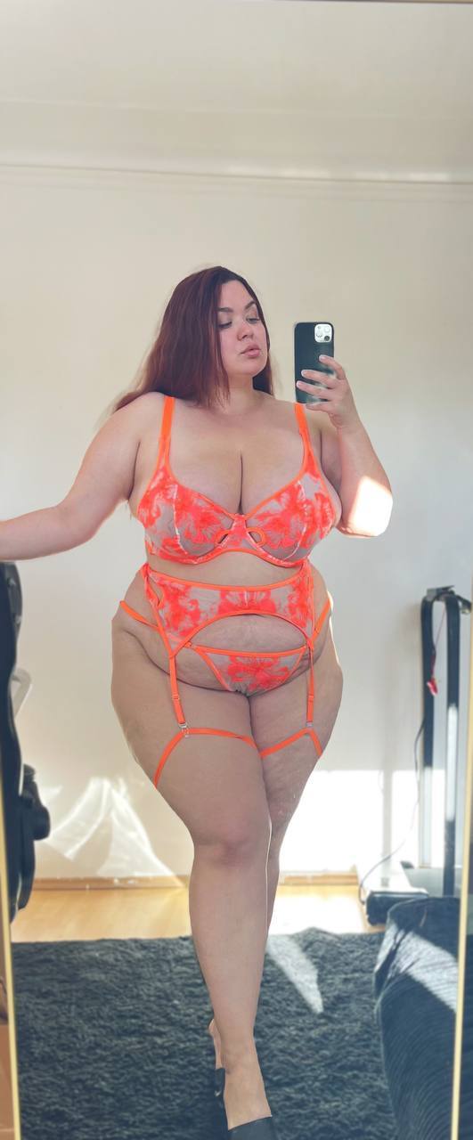 Solo girl takes selfies while wearing revealing lingerie and hosiery