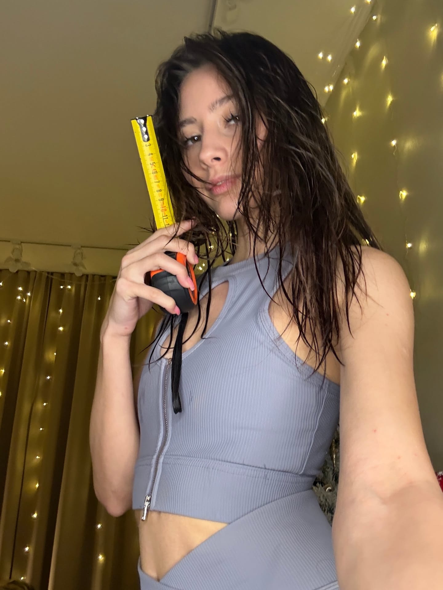Solo girl with long hair shows off her flexibility while undressing