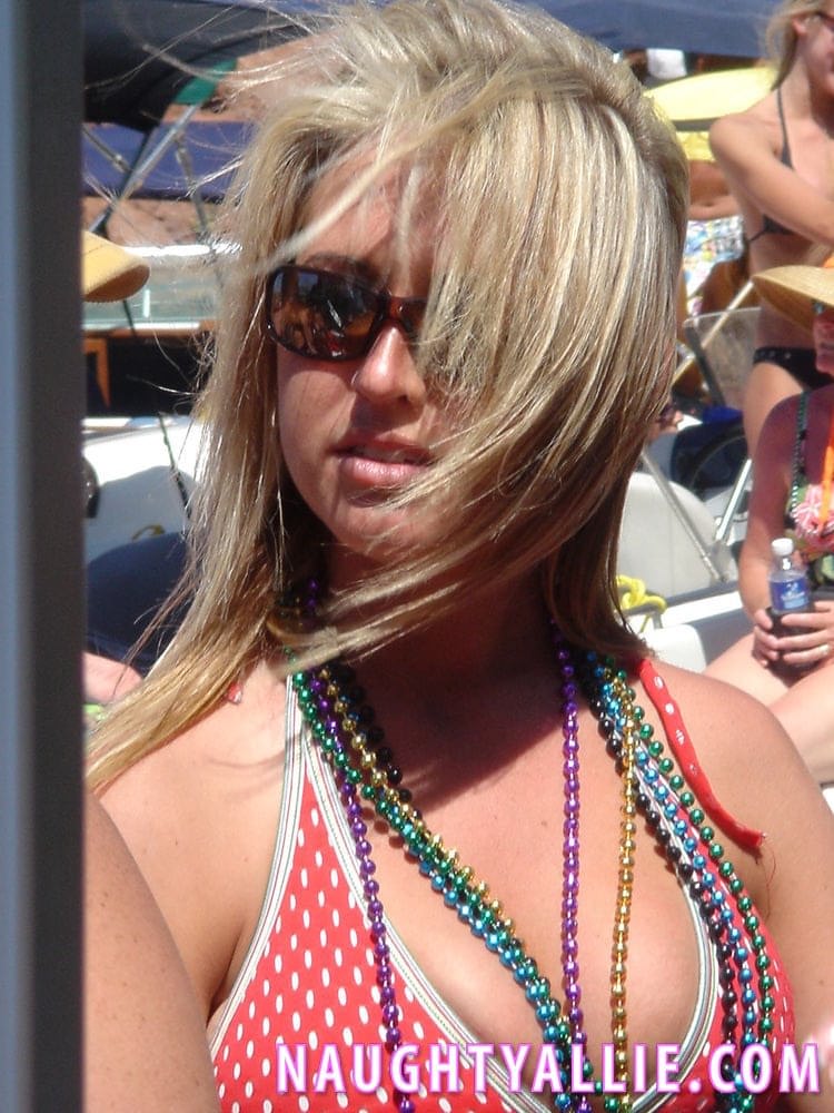 Blonde amateur Naughty Allie engages in lesbian play during a boat party